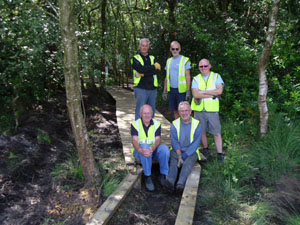 volunteers repair the boardwalk